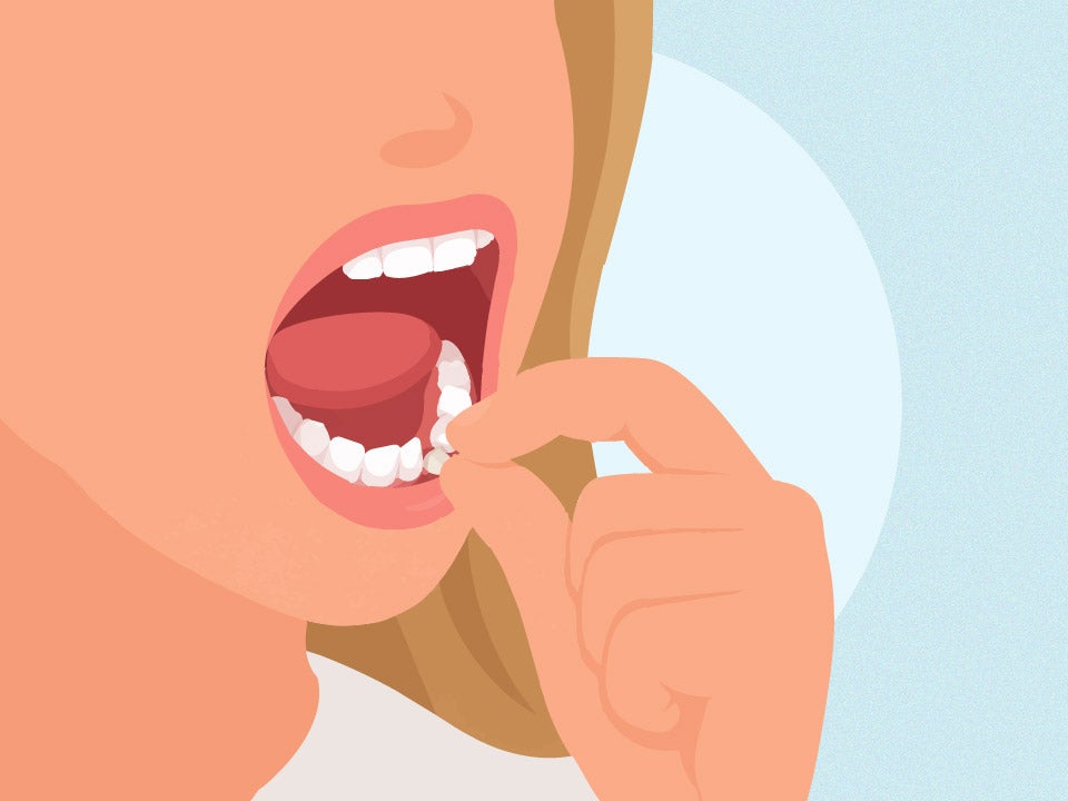 girl picking at loose tooth