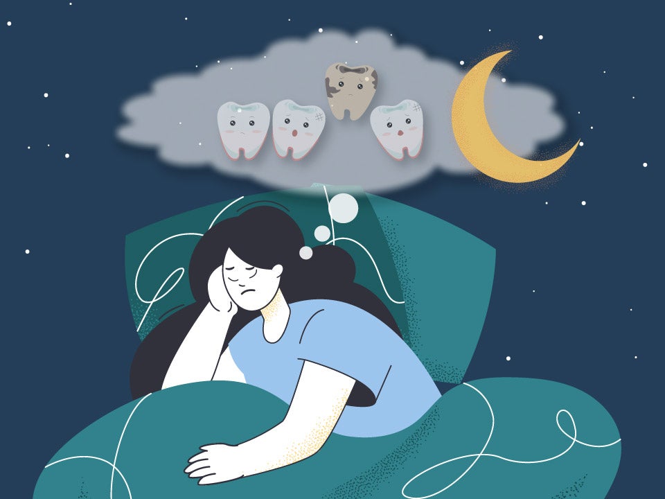 woman in bed dreaming about tooth falling out
