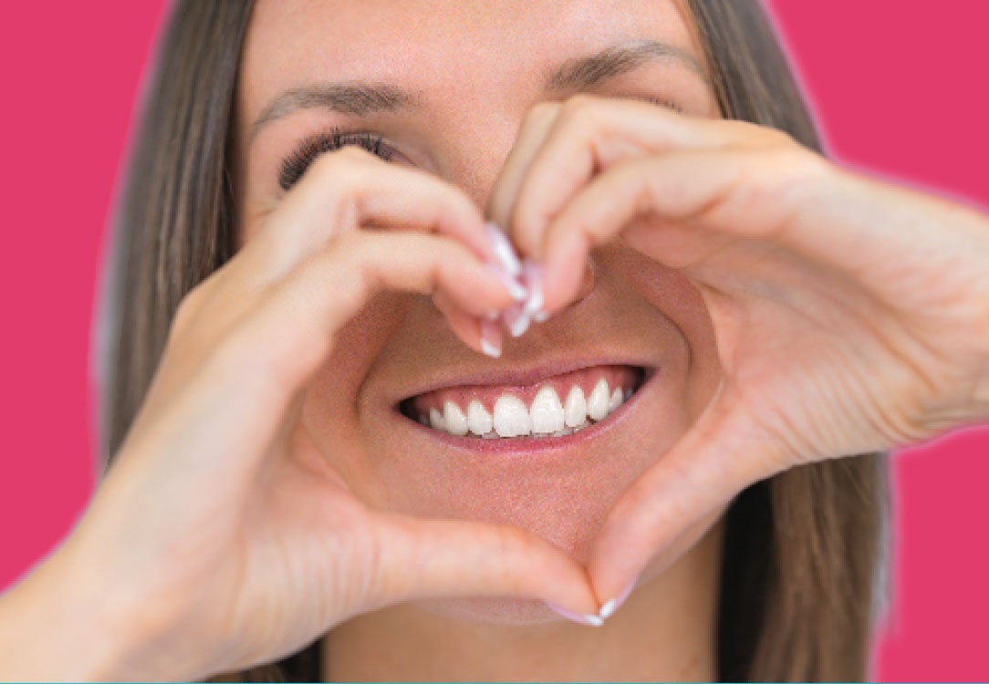 Stock photo of woman making a heart shape using her hands