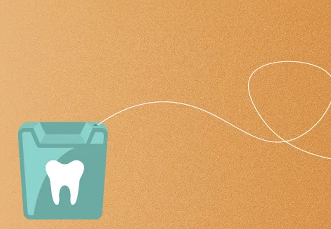 Green box of floss on orange background