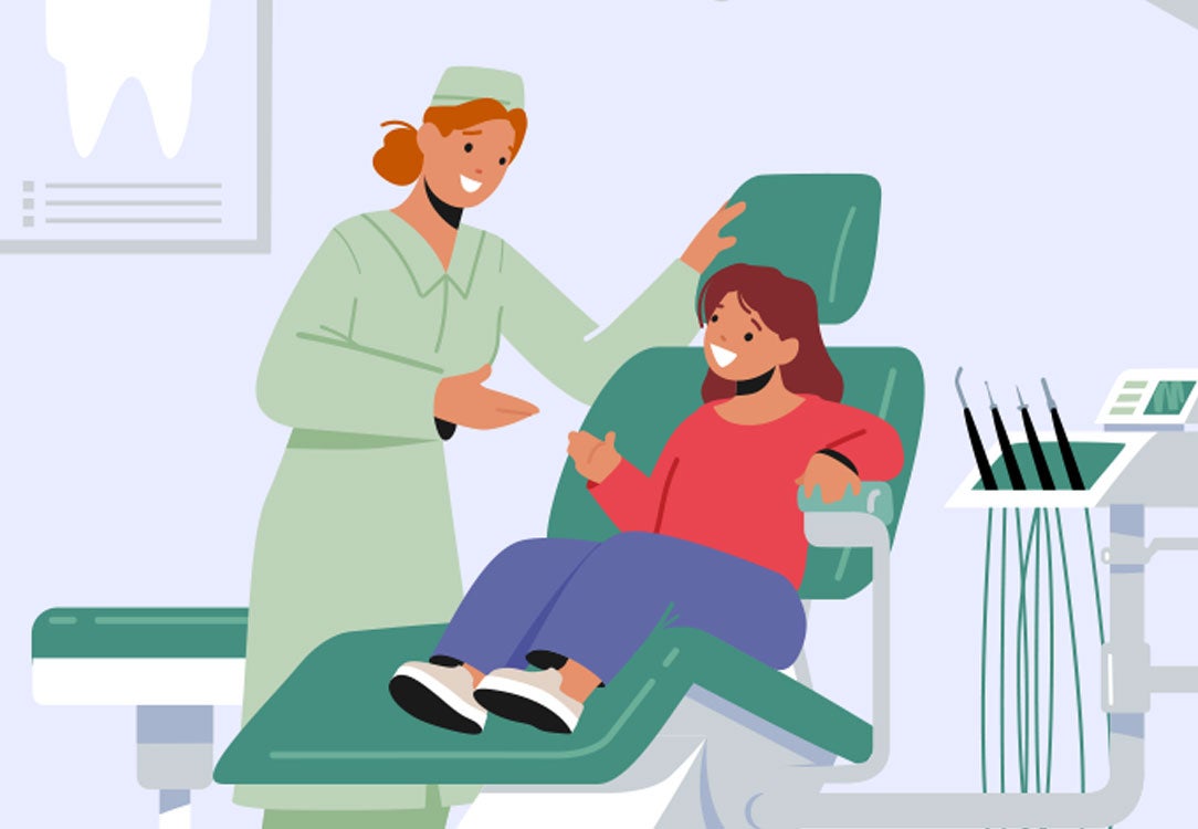 Dentist talking to child in a dental chair