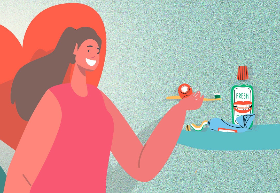 Woman holding toothbrush and floss with mouthwash and toothpaste