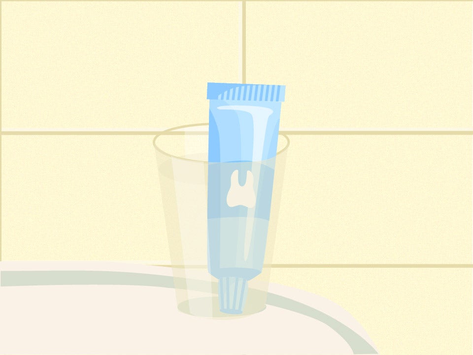 Toothpaste bottle in a cup