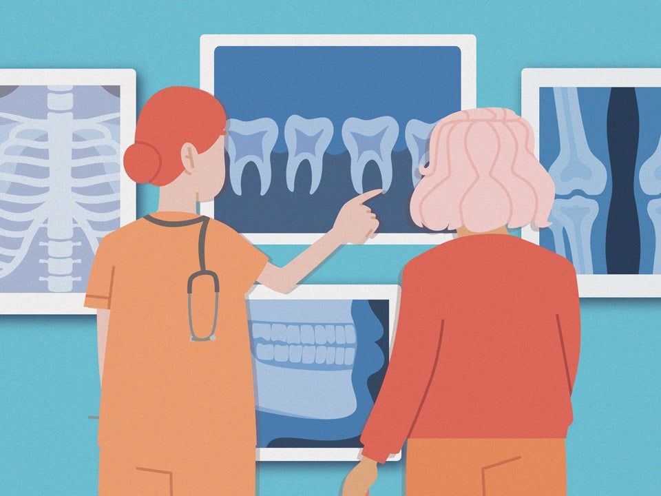 dentist showing patient tooth x-rays