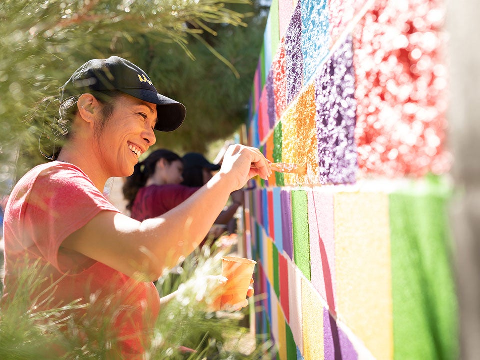 Woman painting on a wall